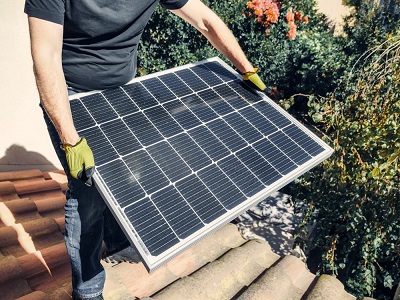 Man holding a solar panel